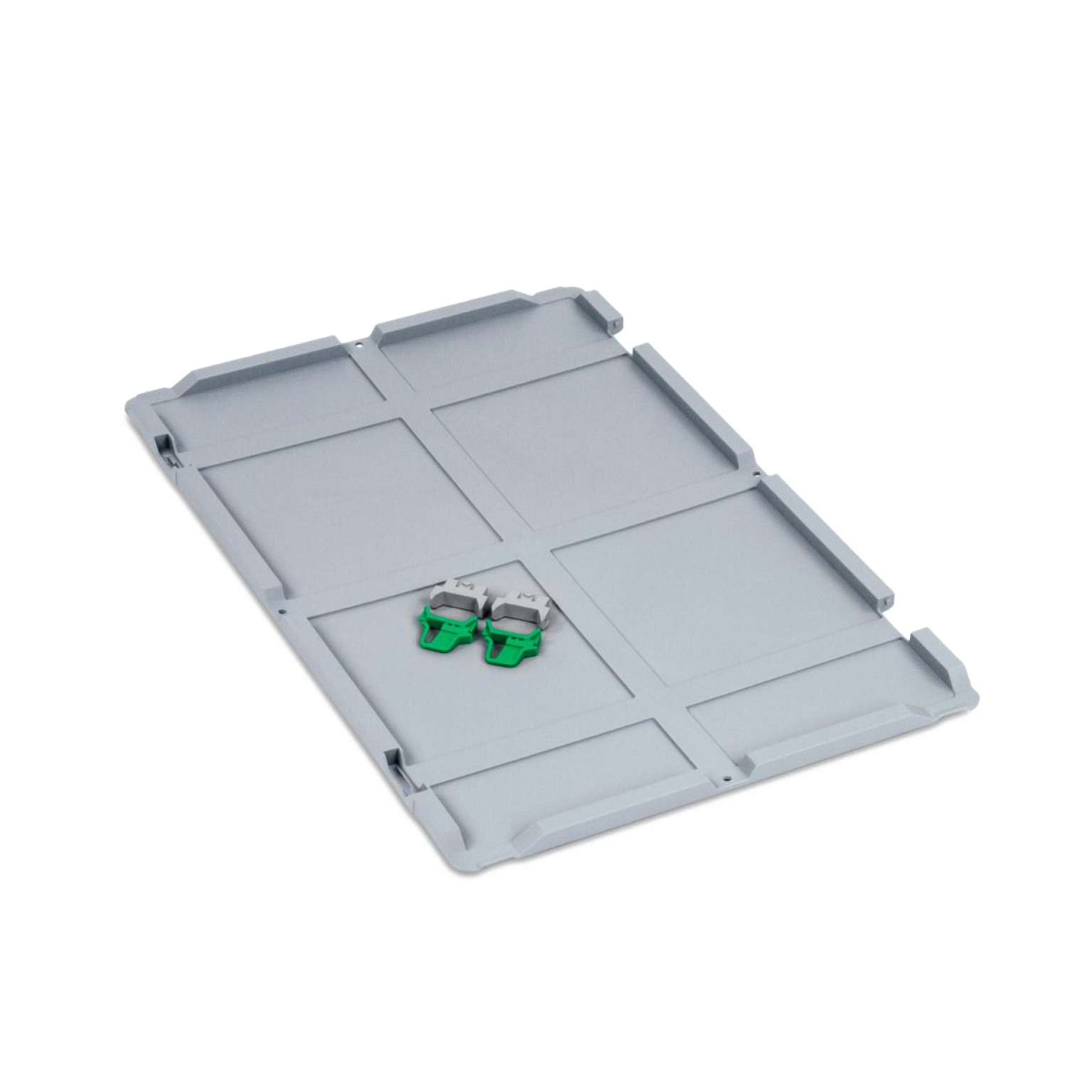 A gray plastic base plate features sections for organization, with two green and gray clamping clips positioned on top. The surface is flat and designed for storage or transportation applications.