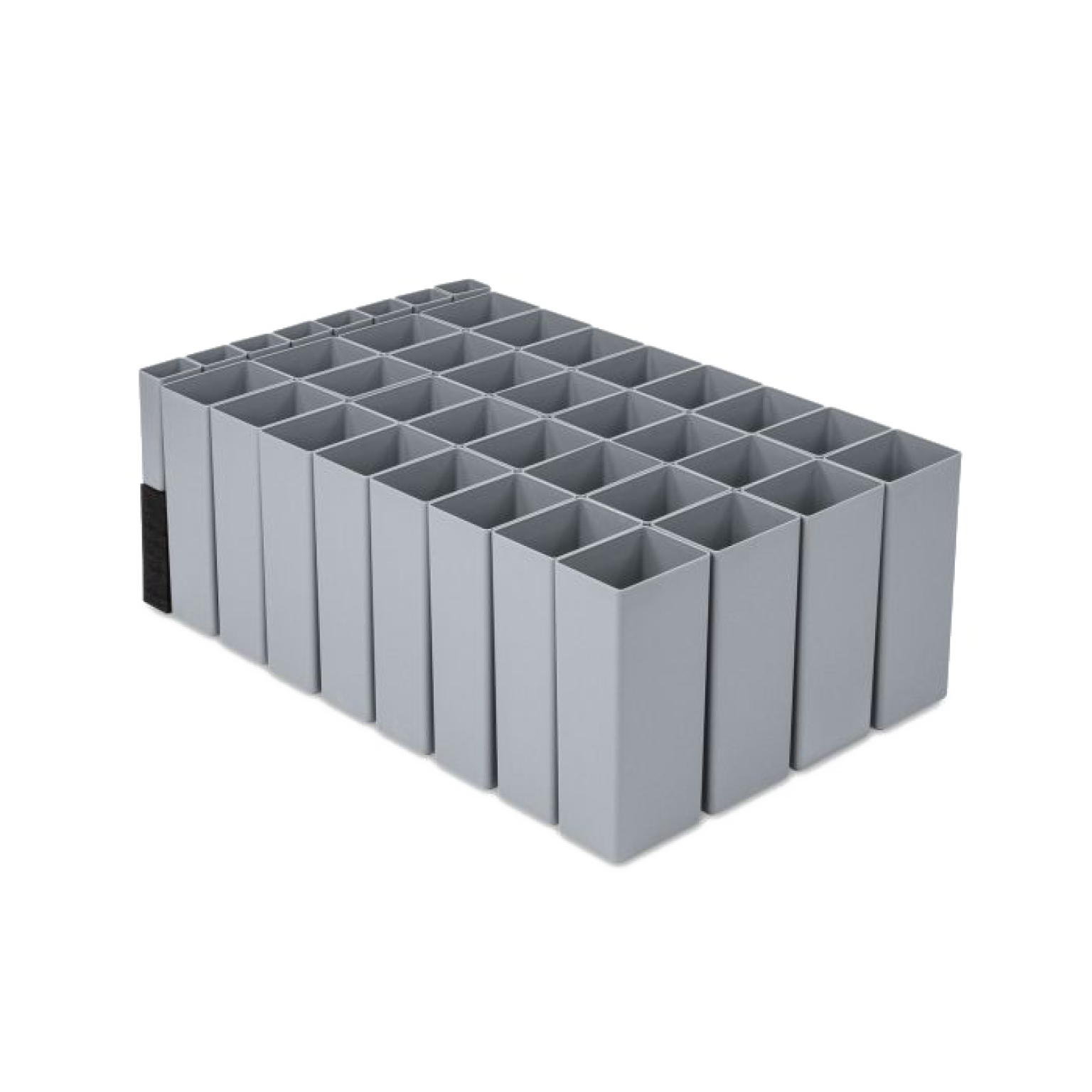 A gray plastic storage rack features multiple rectangular slots arranged in a grid pattern, designed for organizing materials. It is placed on a neutral background, highlighting its uniform shape and design.